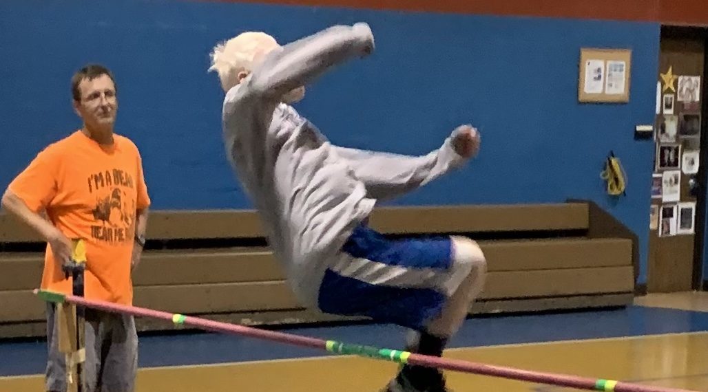 A student leaping over a pole vault.