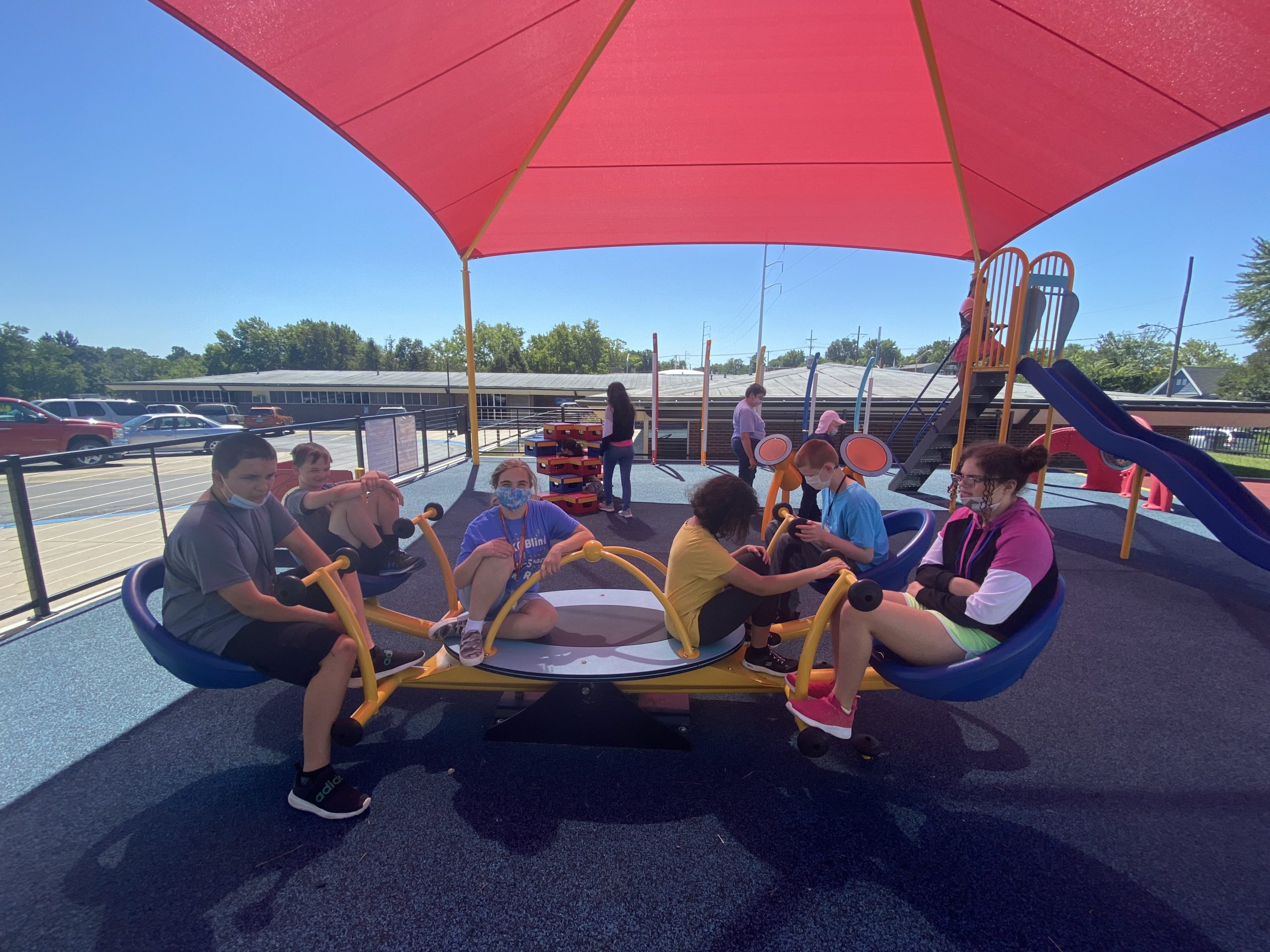 6 students balance themselves on a teeter totter