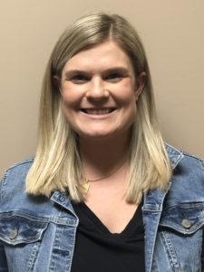 Valerie Pollan with shoulder length blonde hair wearing a black top with jean jacket.