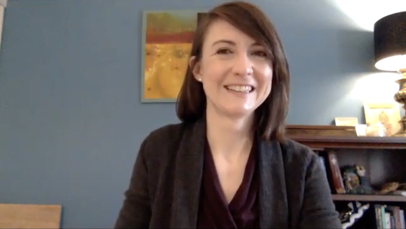 Dr. Corinna Bauer with short dark hair smiles in a zoom meeting