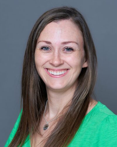 Tammy Warford, smiling with long brown hair