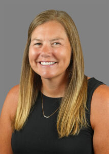 Headshot of Leah Enright, with long blonde hair, smiling for the camera.